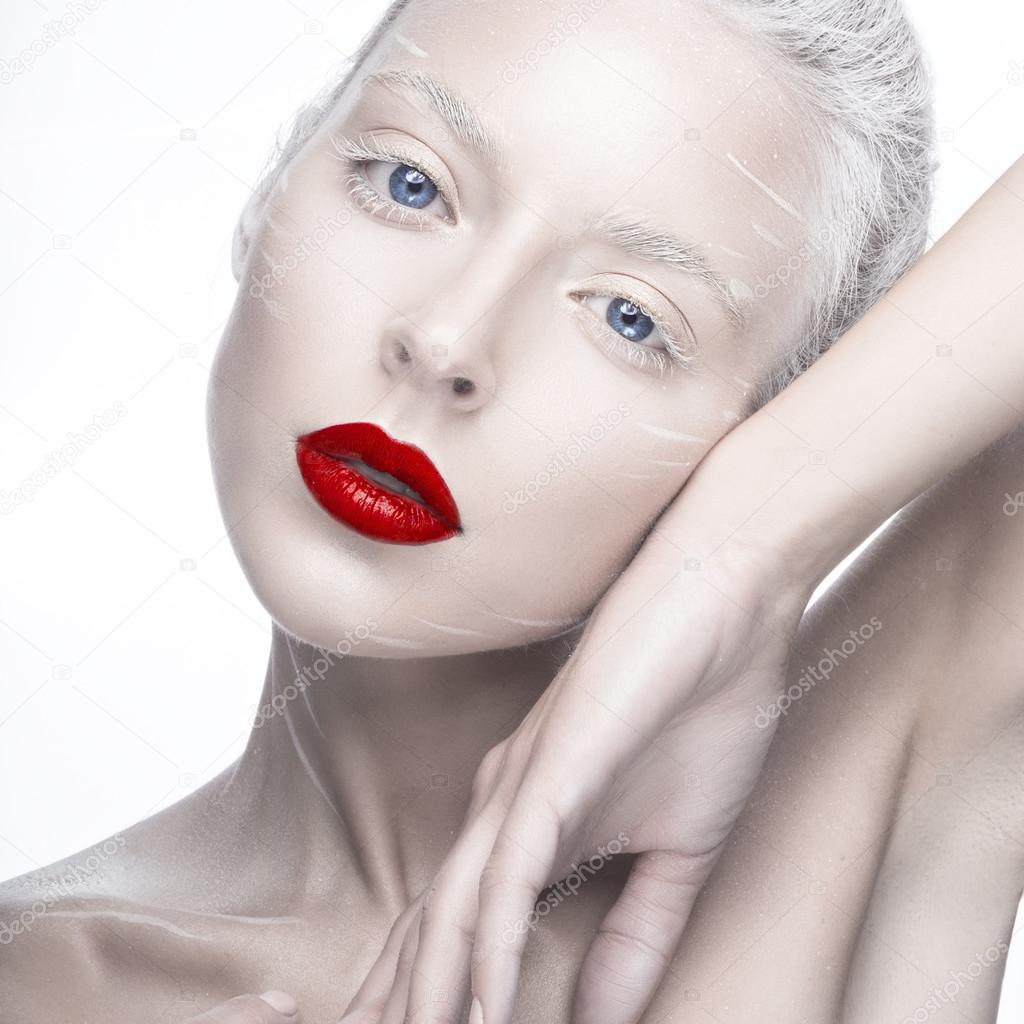 Beautiful girl in the image of albino with red lips and white eyes. Art beauty face.