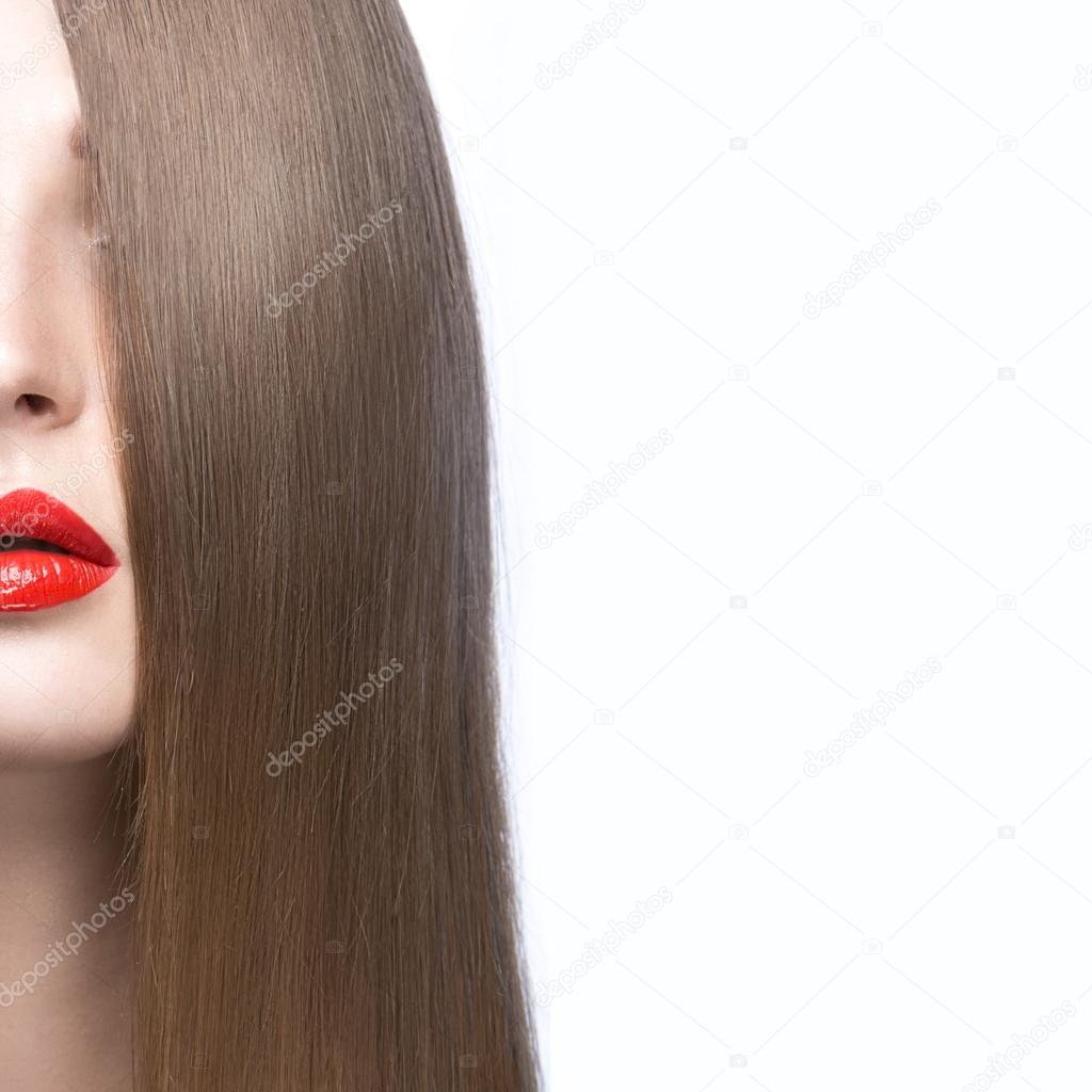 Beautiful girl with a perfectly smooth hair and red lips. Beauty face.