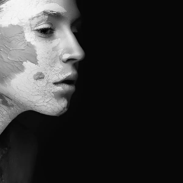 Beautiful girl with mud on his face. Cosmetic mask. Beauty face.  Black&white photo