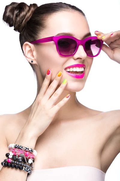 Beautiful girl in pink sunglasses with bright makeup and colorful nails. Beauty face. Stock Picture