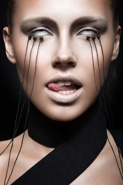 Beautiful girl with creative make-up in Gothic style and the threads of eyes. Art beauty face. — Stock Photo, Image