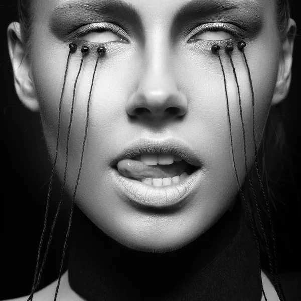 Beautiful girl with creative make-up in Gothic style and the threads of eyes. Black and white photo — Stock Photo, Image