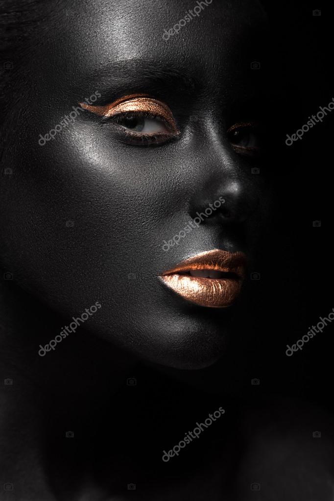 Fashion portrait of a dark-skinned girl with color make-up. Beauty face ...