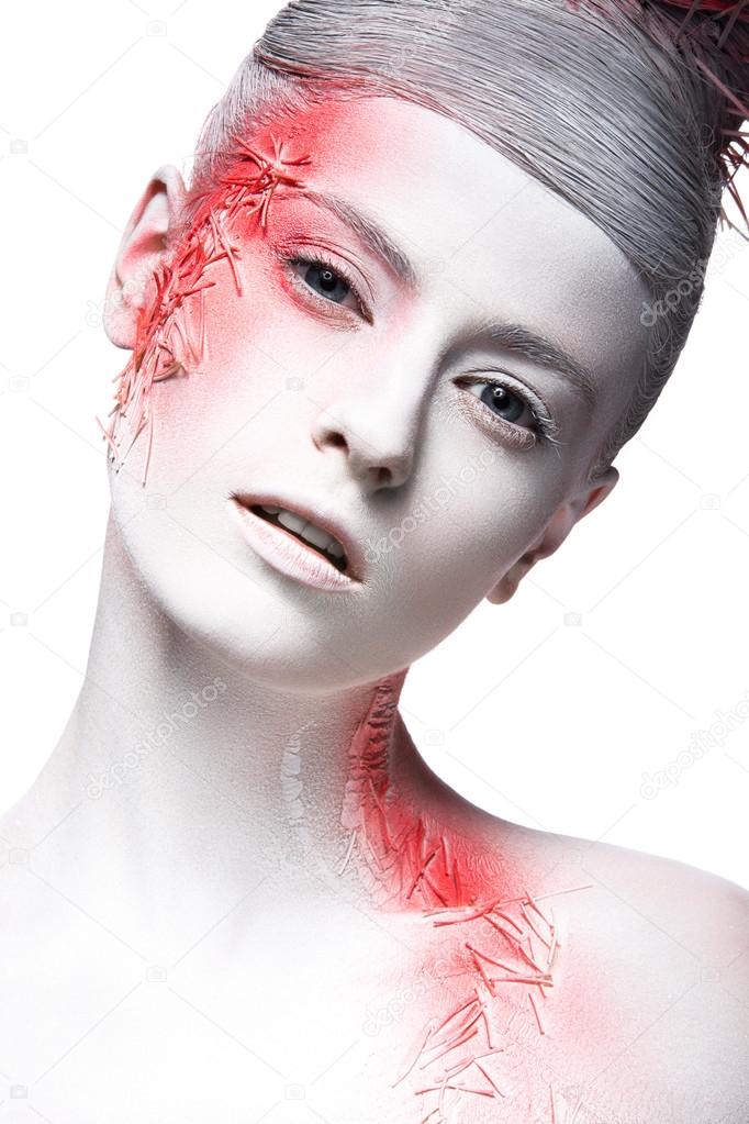 Art fashion girl with white skin and red paint on the face.  Creative art beauty. 