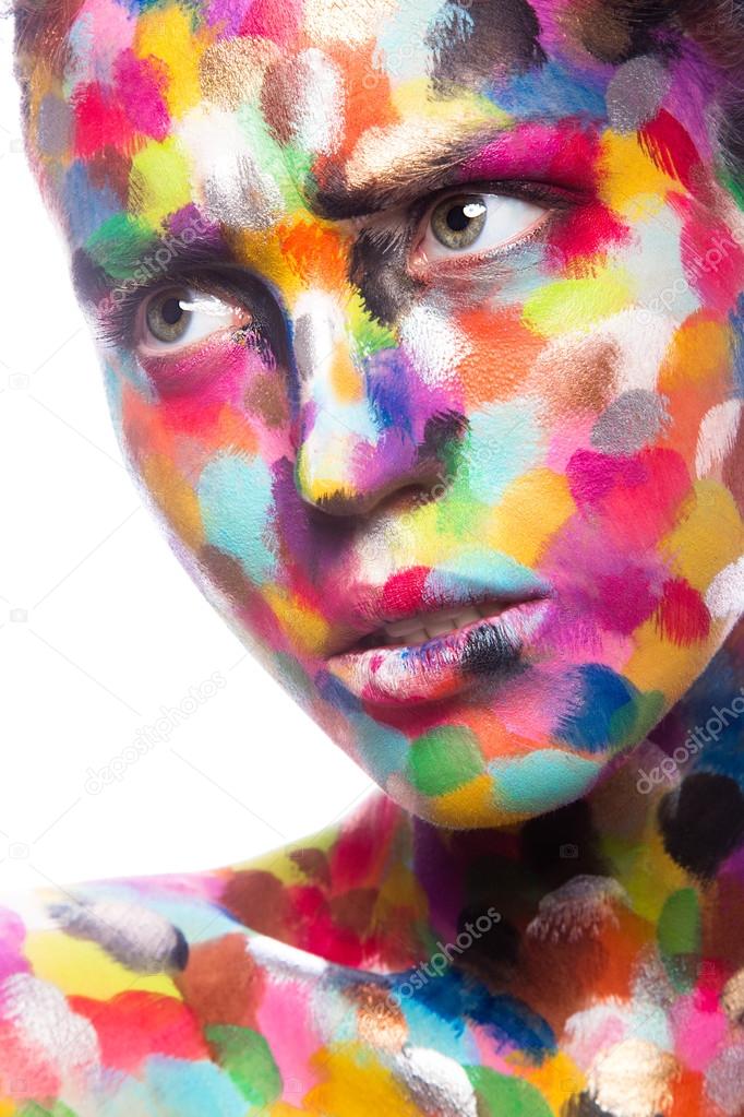 Girl with colored face painted. Art beauty image. 