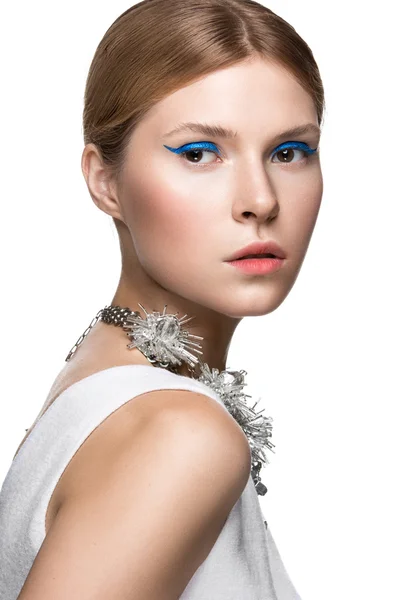 Beautiful fashionable girl with the blue arrows on eyes, smooth hair and original decoration around her neck. Model in white. Beauty face. — Stock Image Beautiful fashionable girl with the blue arrows on eyes, smooth hair and original decoration around her neck. Model in white. Beauty face. Stock Photo