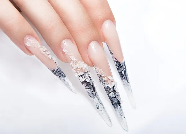 Human fingers with long fingernail and beautiful manicure over gray