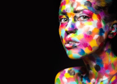 Girl with colored face painted. Art beauty image.  clipart