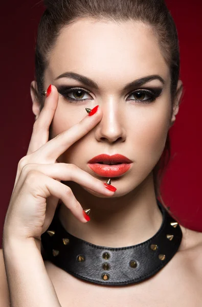 Mulher bonita em estilo gótico, maquiagem à noite e unhas vermelhas com espinhos . — Fotografia de Stock