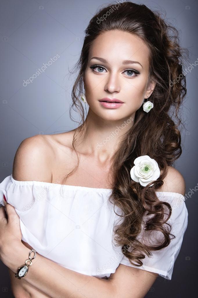 Portrait of a beautiful girl with flowers on her hair. Beauty face. Wedding image in the style boho