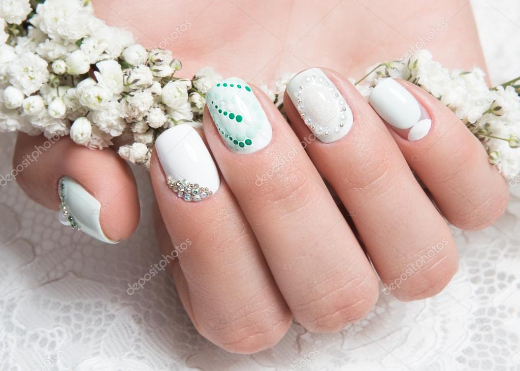 Wedding manicure for the bride in gentle tones with flowers. Nail Design. Close-up.