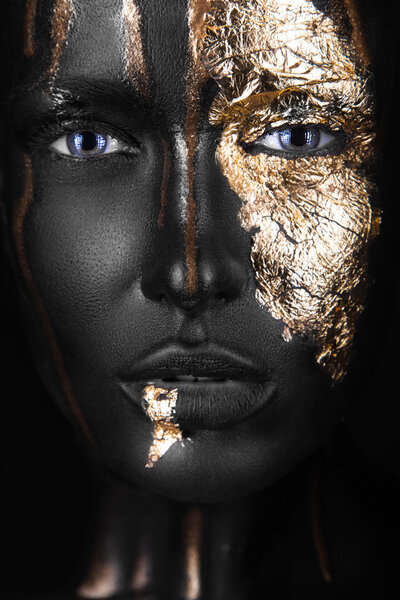 fashion portrait of a dark-skinned girl with gold make-up. Beauty face.