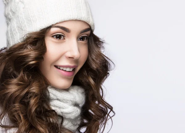 Hermosa chica con maquillaje suave, rizos y sonrisa en sombrero de punto blanco. Imagen de invierno cálido. Rostro de belleza. — Foto de Stock