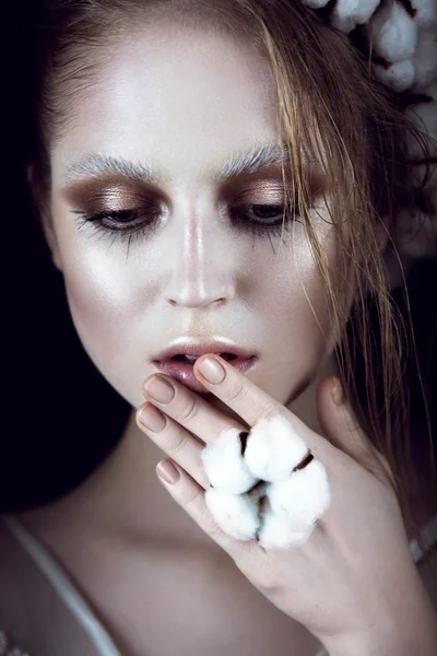 Art fashion girl with creative makeup and cotton in her hair. Beauty face. — Stock Photo, Image