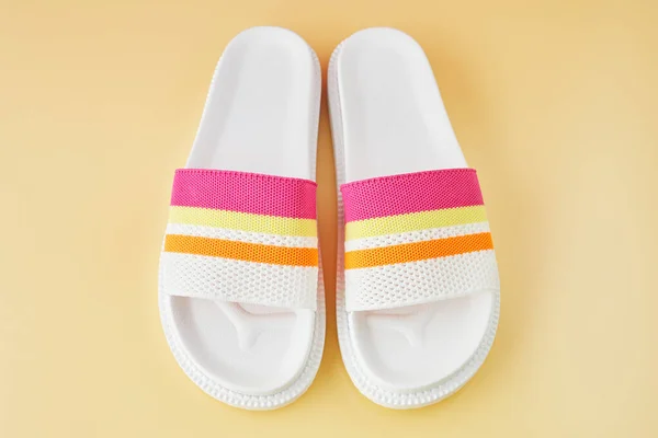 Pair of colorful multicolored rainbow flip flops or sandals on pastel background. Beach holidays and Summer concept. — Stock Photo, Image