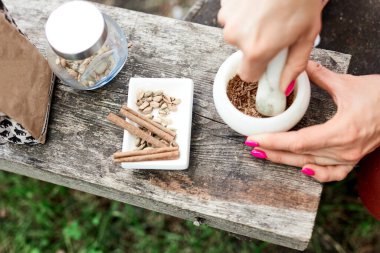 Sıcak bir şeyler içelim. Doğada baharatlı kahve pişirme süreci. Arka plan - kamp ve orman.