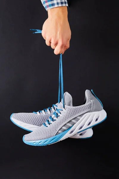 Hand Holds Hanging Gray Running Sneakers Laces Black Background Hand — Stock Photo, Image