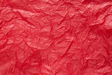 Tasarım için kırmızı buruşmuş kağıt veya yaprak dokusu arka planı. Metin için duvar kağıdı.