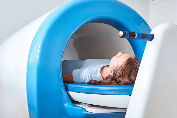 Magnet therapy system or Magnetic resonance imaging machine. Patient in a medical office.