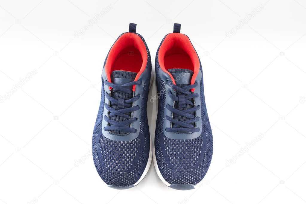 Pair of new unbranded blue running shoes or sneakers on white background. Fashion sport footwear or trainers for fitness.