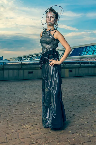 Beautiful woman in a silver dress with crystals on the face — Stock Photo, Image