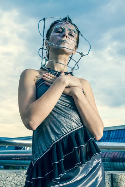 Beautiful woman in a silver dress with crystals on the face — Stock Photo, Image