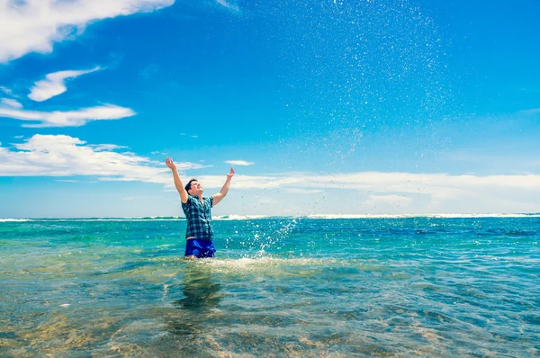 Человек развлекается в воде на пляже — стоковое фото