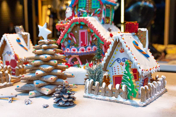 gingerbread house and gingerbread christmas decoration in the snow.