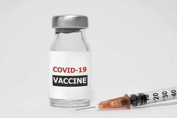 COVID-19 Coronavirus Vaccine and Syringe on white backgrounnd — стокове фото