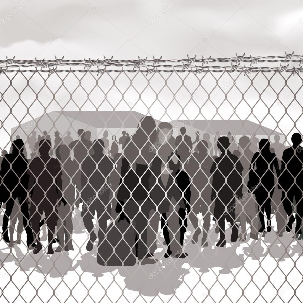 Refugees behind chain link fence