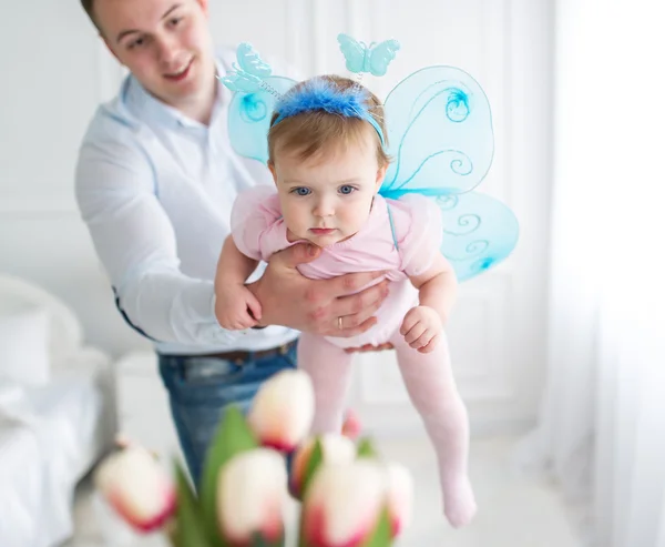 The little fairy in a pink dress and her father. — Stock Photo, Image