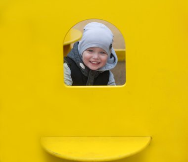 Oğlan sarı pencereden görünüyor.