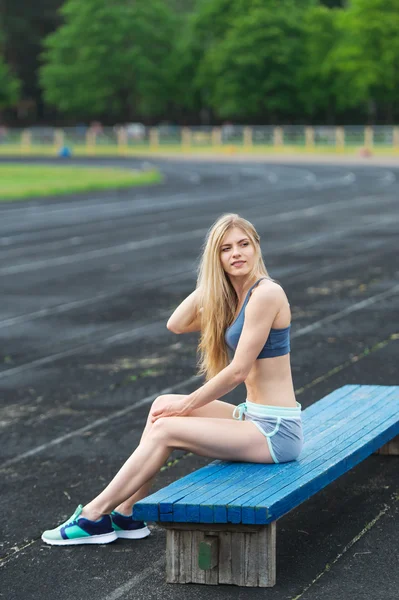 The sportswoman has rest on bench after training. — Stock Photo, Image