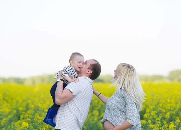 Family from three people on a rape field — Stock Photo, Image