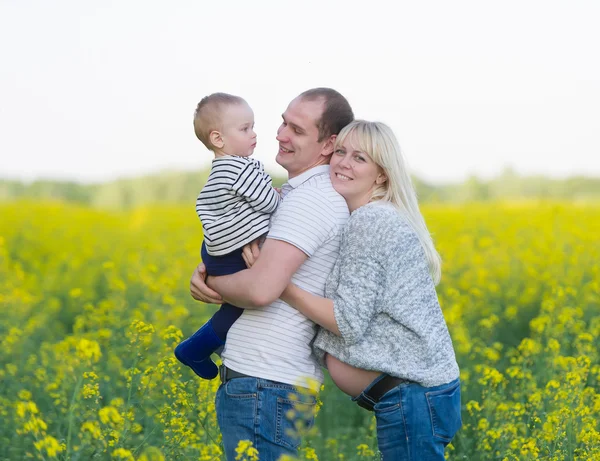 Family from three people on a rape field — Stock Photo, Image