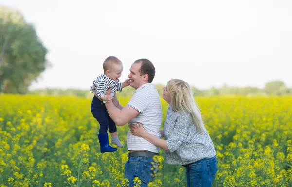 Family from three people on a rape field — Stock Photo, Image