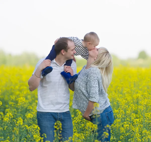 Family from three people on a rape field — Stock Photo, Image