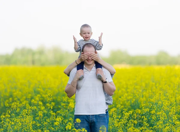 Family from three people on a rape field — Stock Photo, Image