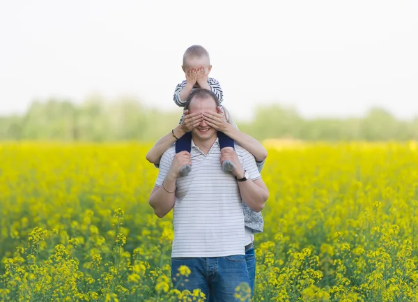 Family from three people on a rape field — Stock Photo, Image