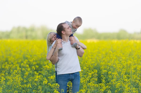 Family from three people on a rape field — Stock Photo, Image