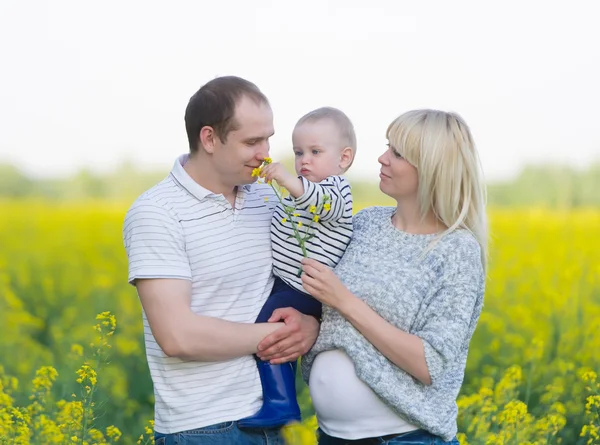 Family from three people on a rape field — Stock Photo, Image