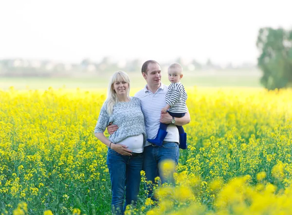 Family from three people on a rape field — Stock Photo, Image