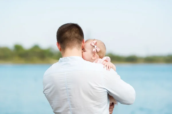 The father holds the little daughter on hands. — Stock Photo, Image