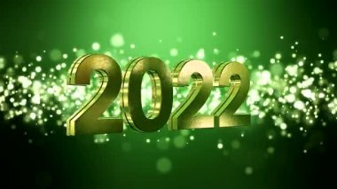 Noel 'in video animasyonu altın ışık parçacıkları yeşil arkaplan üzerine parlıyor ve 2022 rakamları yeni yılı temsil ediyor - tatil kavramı.