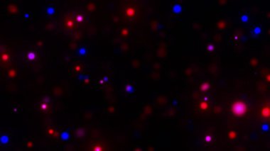 Kırmızı ve mavi parlayan parçacıklar arka planda hareket eder.