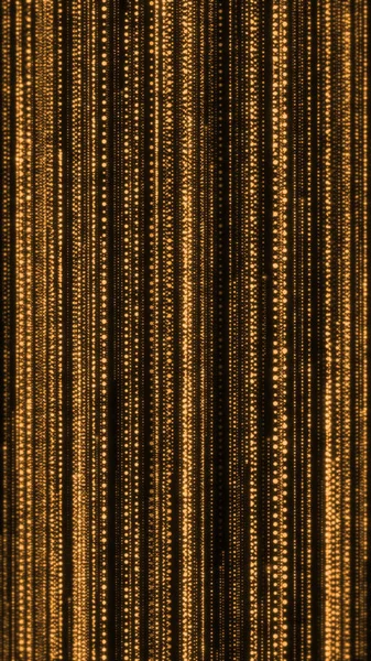 Glowing golden vertical lines falling on dark background, elegant abstract technology background.