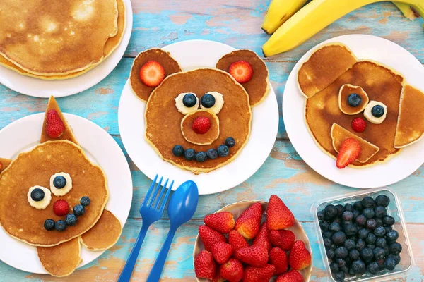 Fun food for children. Set of plates with funny pancakes. Creative idea for kids breakfast. — Stock Photo, Image