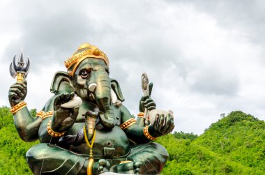 Green Ganesha Hindu God statue close up on natural background clipart