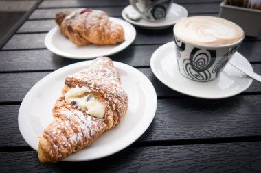 Croissants served with cappuccino clipart