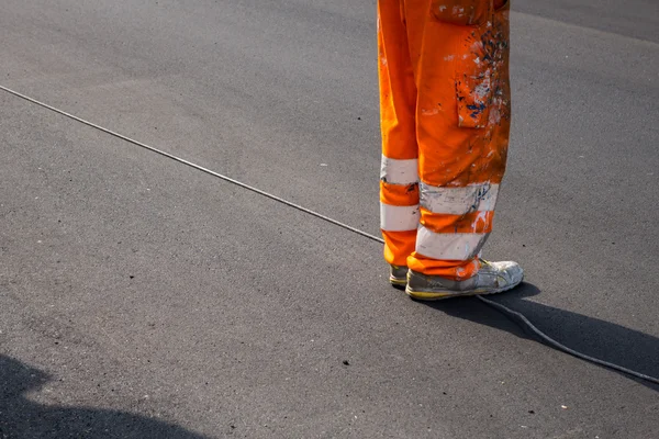 Piernas de un trabajador en uniforme naranja —  Fotos de Stock